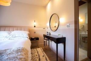 a bedroom with a bed and a mirror and a table at TOFY (The Old Forge York) in York