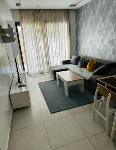 a living room with a couch and a table at Tazi studio 2 in Casablanca