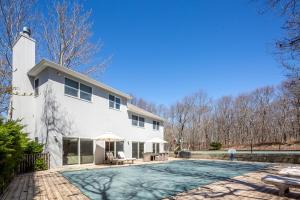 una casa blanca con piscina frente a ella en Southampton Serenity, en Southampton