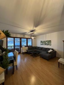 a living room with a couch and a table at Apartman Nai in Bjelašnica
