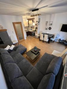 a living room with a couch and a table at Apartman Nai in Bjelašnica