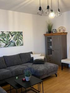 a living room with a couch and a table at Apartman Nai in Bjelašnica +3 photos