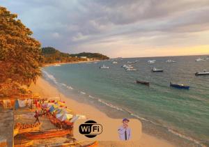a view of a beach with boats in the water at Chambres d'hôtes Beluga in Nosy Be