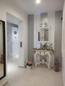 a bathroom with a white vanity and a mirror at ÁTICO RILQUE, Apartamentos Independientes con Jacuzzi Privado y Terraza en Ronda in Ronda +62 photos