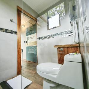 La salle de bains est pourvue de toilettes, d'un lavabo et d'une douche. dans l'établissement Hotel Contenedores Corporativos, à Platanal