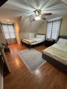 a bedroom with two beds and a ceiling fan at The Hammock in Williamstown