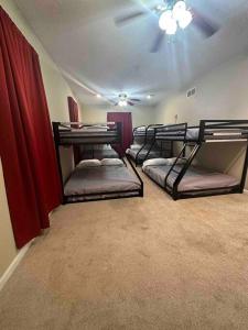 three bunk beds in a room with a ceiling at The Hammock in Williamstown