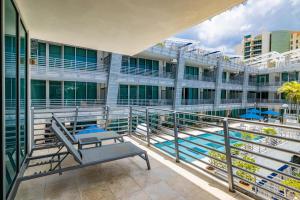 a balcony with a bench and a swimming pool at Suites Ocean Drive Hotel in Miami Beach