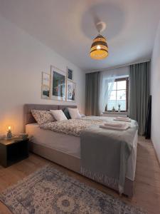 a bedroom with a large bed and a window at APARTAMENT Pod Lasem Jedlina Zdrój in Jedlina-Zdrój
