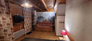 a living room with a couch and a television at Gite les Boleros in Queige