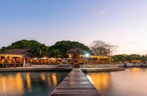 a bridge over a body of water with a restaurant at Hotel Isla del Encanto in Baru