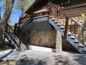 a wooden staircase on the side of a house at EL BOSQUE ENCANTADO in La Estación