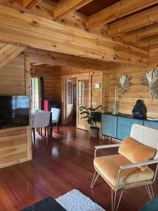 a living room with wooden walls and wooden floors at EL BOSQUE ENCANTADO in La Estación