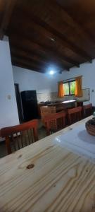 a dining room with a wooden table and chairs at El Remanso del Casero in Gualeguay