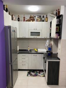 a kitchen with a stainless steel refrigerator at Apartman Stanić in Bosanska Gradiška