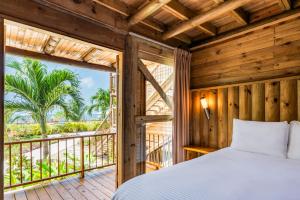 a bedroom with a bed and a balcony at Hotel Isla del Encanto in Barú +75 photos