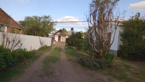 a dirt road in front of a house at Refugio Amaicha in Embalse