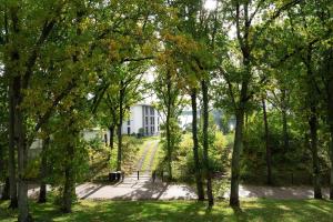 a view of a white house through trees at Apartment "Haff Ahoi" - Haffresidenz in Garz-Usedom