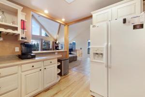 a kitchen with white appliances and a white refrigerator at Fawn Court - Wildernest in Silverthorne