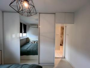 a bedroom with a sliding glass door with a bed at Scandinavian Retkinia Distric in Łódź