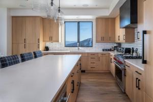 a kitchen with wooden cabinets and a large white counter top at 9 Deep Forest Drive by Moonlight Basin Lodging in Big Sky