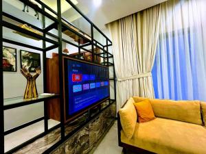 a living room with a couch and a television at COMFORT & LUXURY HOME in Islamabad