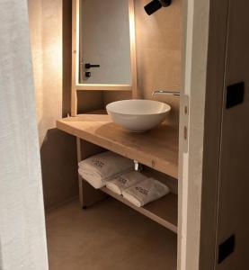 a bathroom with a sink and a bowl on a shelf at Faces & Places Boutique Hotel in Tirana +171 photos
