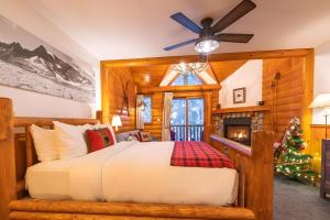 a bedroom with a bed and a christmas tree at Baker Creek By Basecamp in Lake Louise