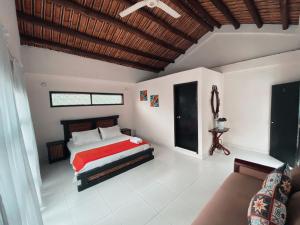 um quarto com uma cama e um sofá em LAS PALMAS MELGAR em Melgar