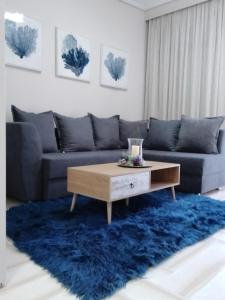 a living room with a couch and a coffee table at Volos Hospitality, Central Apartment in Volos