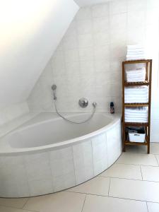 a bathroom with a bath tub in the attic at Haus Seeblick in Allersberg