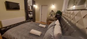 a bedroom with a bed with two pillows on it at OLIVE TREE - 2 Master bedroom (sleeps 6) in Blackpool