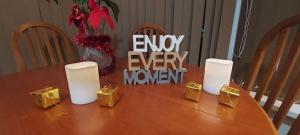 a table with white candles and gold gifts on it at OLIVE TREE - 2 Master bedroom (sleeps 6) in Blackpool +13 photos