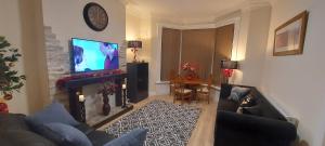 a living room with a fireplace and a tv at OLIVE TREE - 2 Master bedroom (sleeps 6) in Blackpool
