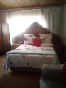 a bed with pillows on it in a room at Nafi guest house in Phuthaditjhaba