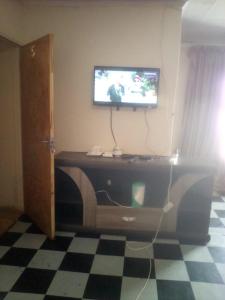 a living room with a tv on top of a dresser at Nafi guest house in Phuthaditjhaba