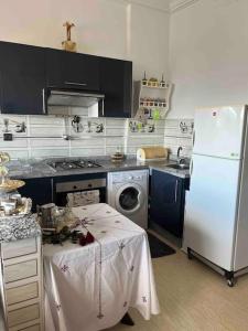 a kitchen with a refrigerator and a table in it at Your privat peace place in Tangier