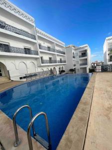 a large swimming pool in front of a building at Your privat peace place in Tangier