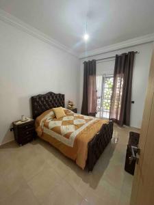 a bedroom with a bed and a large window at Your privat peace place in Tangier