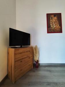 a television on a wooden dresser in a room at Casa Albergo Rende in Quattromiglia