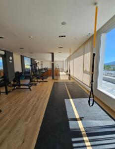 a gym with several treadmills and a large window at Veneto Village Departamento 5min De Carlos Paz- Vista al lago in Villa Parque Siquiman