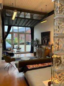 a living room with a couch and a table at IJsselliefde in Kampen