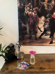 a table with a painting of a group of people at IJsselliefde in Kampen