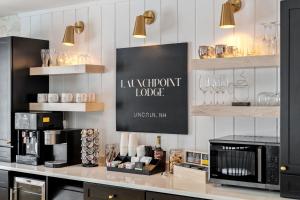 a coffee shop with a counter with glasses on shelves at Launchpoint Lodge: Entire Hotel in Lincoln