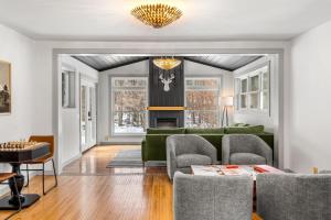 a living room with a green couch and chairs at Launchpoint Lodge: Entire Hotel in Lincoln