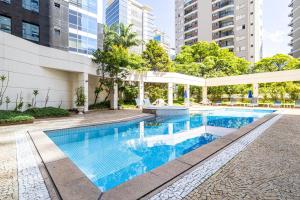 a swimming pool in a building with tall buildings at You Stay at Vila Olimpia - The World in Sao Paulo