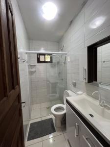La salle de bains est pourvue d'une douche, de toilettes et d'un lavabo. dans l'établissement Pousada Sabores do Mar Laranjeiras, à Balneário Camboriú