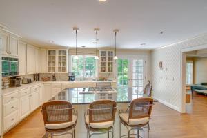 a kitchen with white cabinets and a table and chairs at White Horse Farm with Hot Tub on 41 Acres! in Franklin