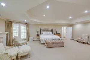 a large bedroom with a bed and two chairs at Pool, Hot Tub and Outdoor Theater Franklin Retreat in Franklin