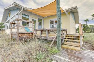 een huis met een veranda en een terras bij Beachfront Alligator Point Retreat Steps to Sand! in Sun N Sand Beaches
